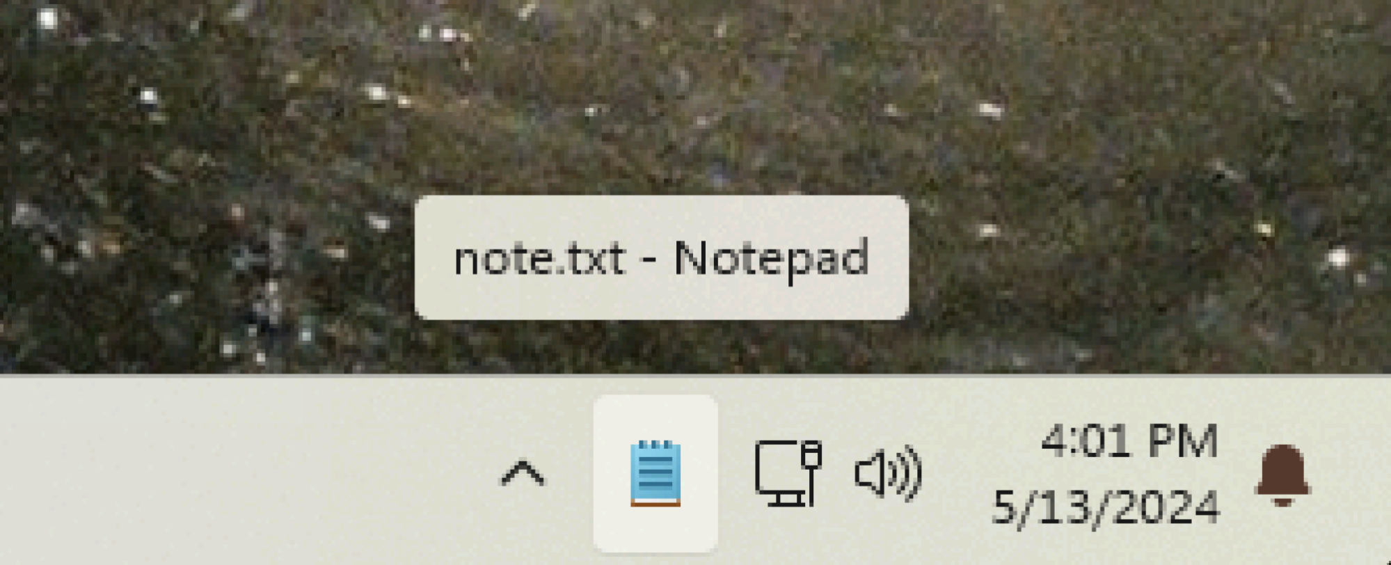 The notepad icon is visible in the system tray—the tooltip says note.txt — Notepad. 