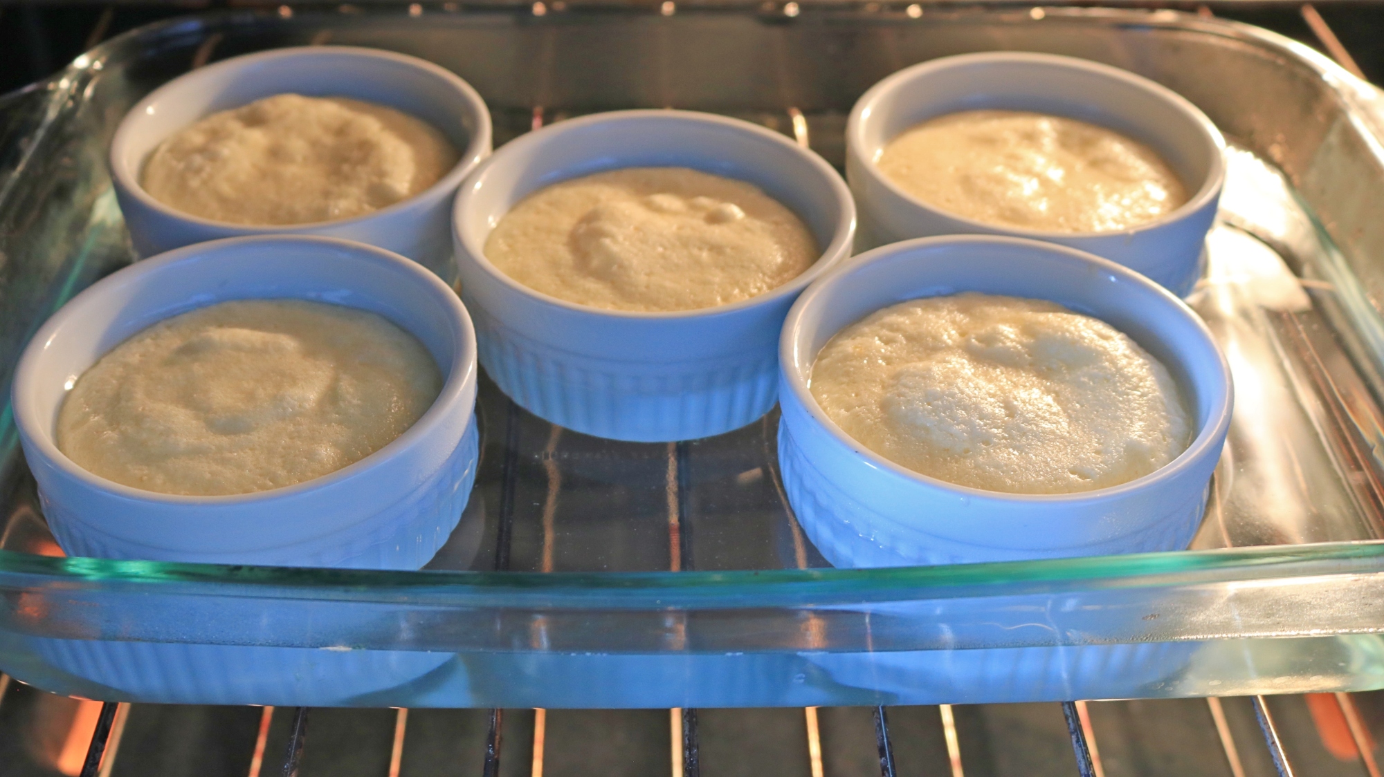 Ramekins with batter in a water bath.